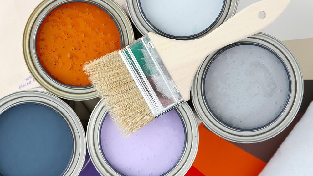 Latas de tinta acrílica com pincel em cima